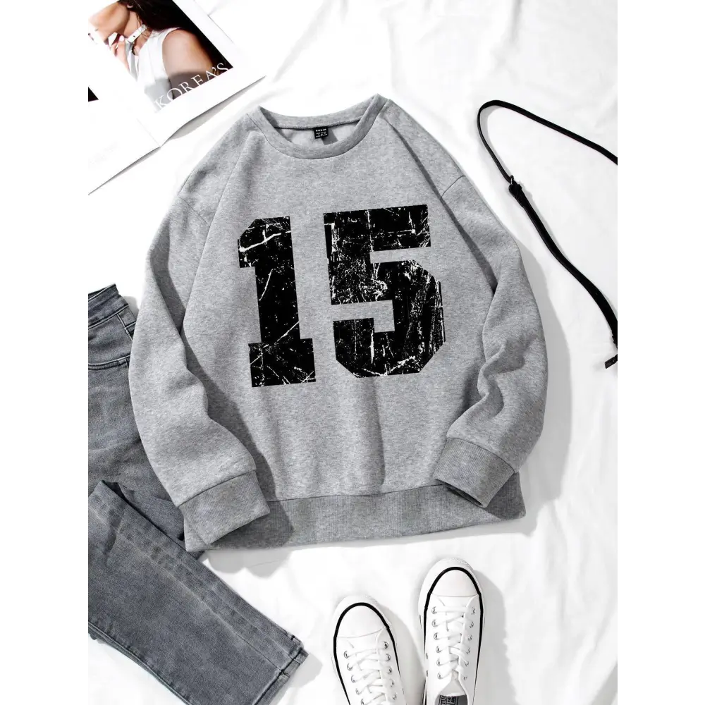 Gray graphic crew neck sweatshirt with black distressed 15 print and ribbed knit collar and cuffs