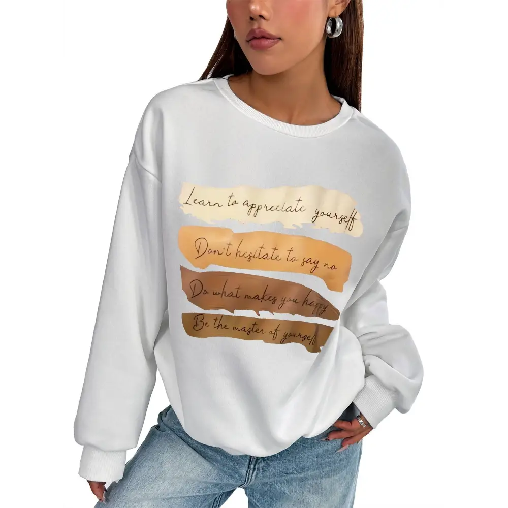 White oversized long sleeve sweatshirt with motivational quote printed in brown cursive on layered beige and tan stripes