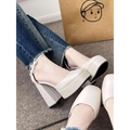 Cream-colored white patent super high heel platform mary janes with chunky block heel and ankle strap