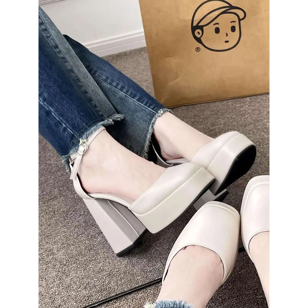 Cream-colored white patent super high heel platform mary janes with chunky block heel and ankle strap