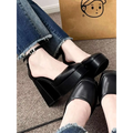 Black platform mary janes with sleek glossy leather finish and ankle strap with silver buckle in super high heel platform style