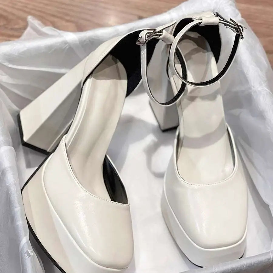 White patent super high heel platform mary janes with black ankle straps and silver-toned hardware details