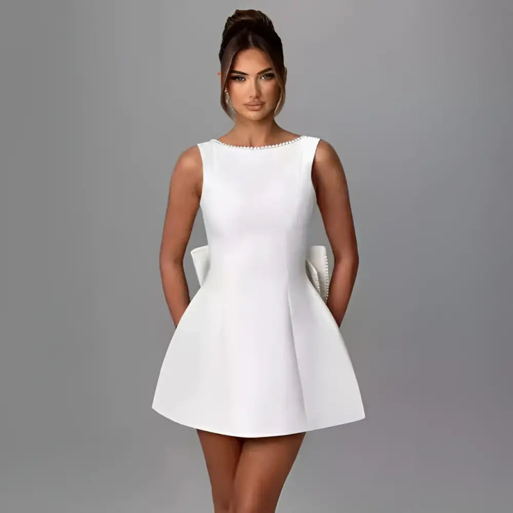 A sleek white satin backless dress summer with a flared skirt and delicate pearl embellished neckline trim