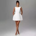 White sleeveless backless dress summer with fitted bodice flared skirt and pearl embellished neckline trim
