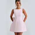 A soft pink sleeveless a-line backless dress summer with pearl embellished neckline and matching bow details at the back