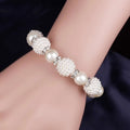 White pearl wedding bracelet with alternating smooth pearls and textured beads accented by silver details for wedding earrings necklace set