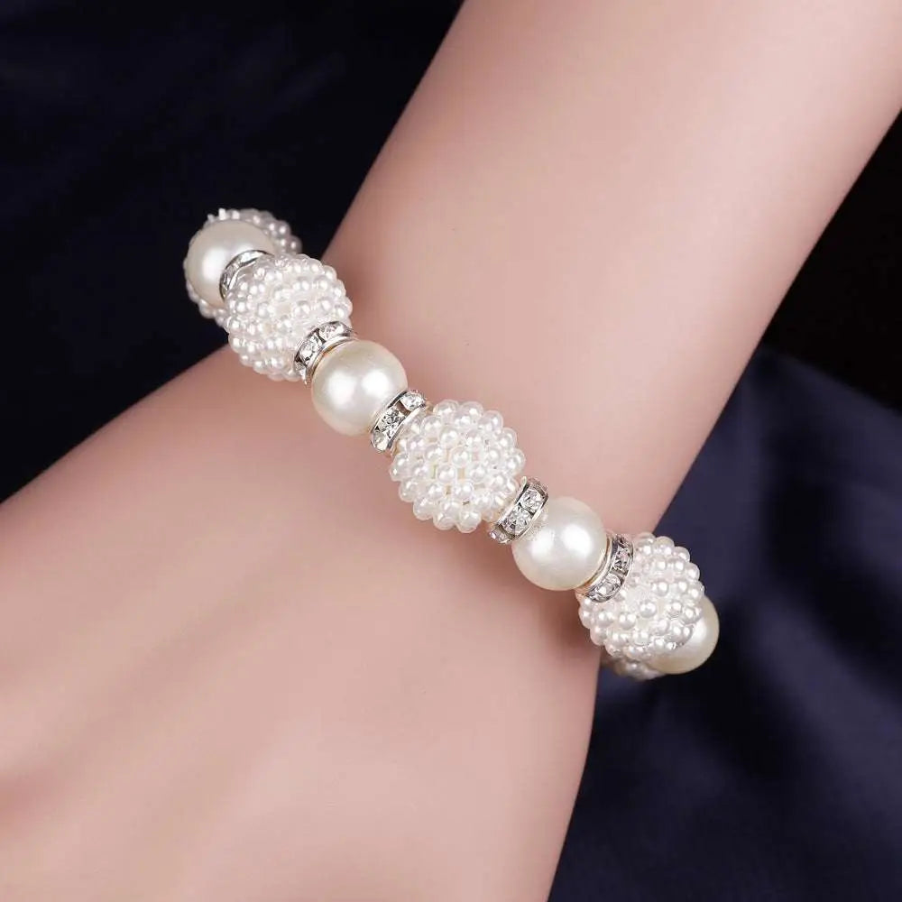 White pearl wedding bracelet with alternating smooth pearls and textured beads accented by silver details for wedding earrings necklace set