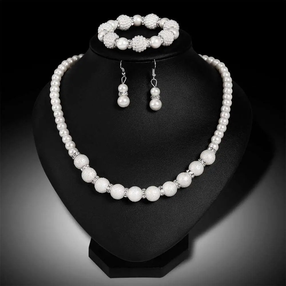 White pearl wedding necklace with textured spherical beads and silver toned accents for wedding earrings necklace set
