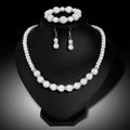Elegant white pearl wedding earrings necklace three piece suit with textured spherical beads and silver accents