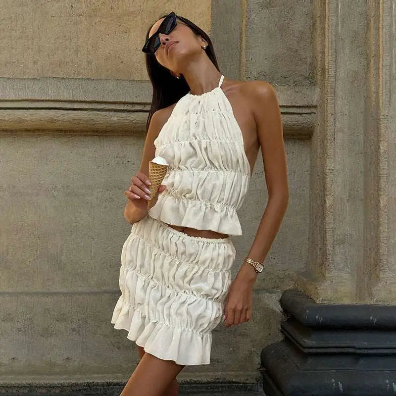 White pleated lace-up flounce skirt two-piece set with ruched halter top in a pleated flounce mini style