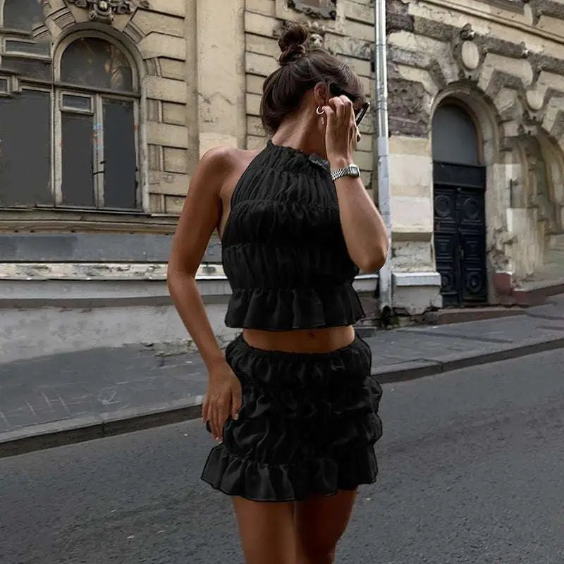 Black ruffled halter top with matching lace-up flounce skirt two-piece highlighting pleated flounce mini design