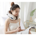 White plush u shaped massage pillow neck device with control buttons and adjustable straps for comfort
