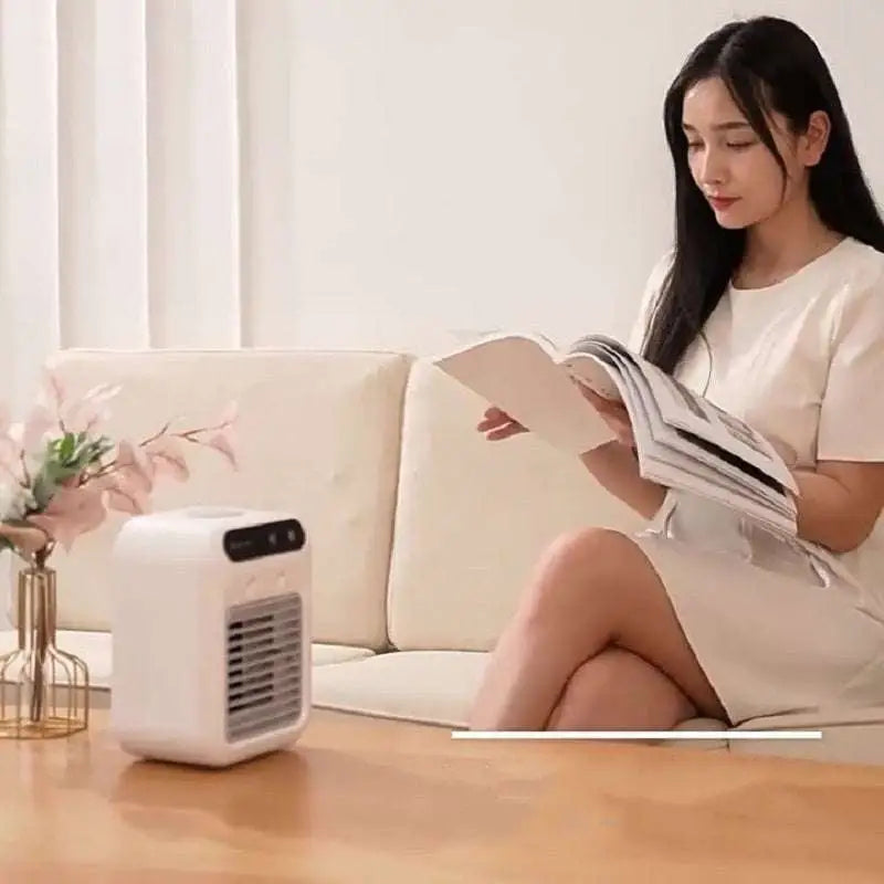 White portable air conditioner mini cooler fan with a black control panel and front grille for compact cooling