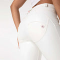 White pu leather high waisted skinny pants with glossy finish and subtle pink accents on zipper pull and brand patch