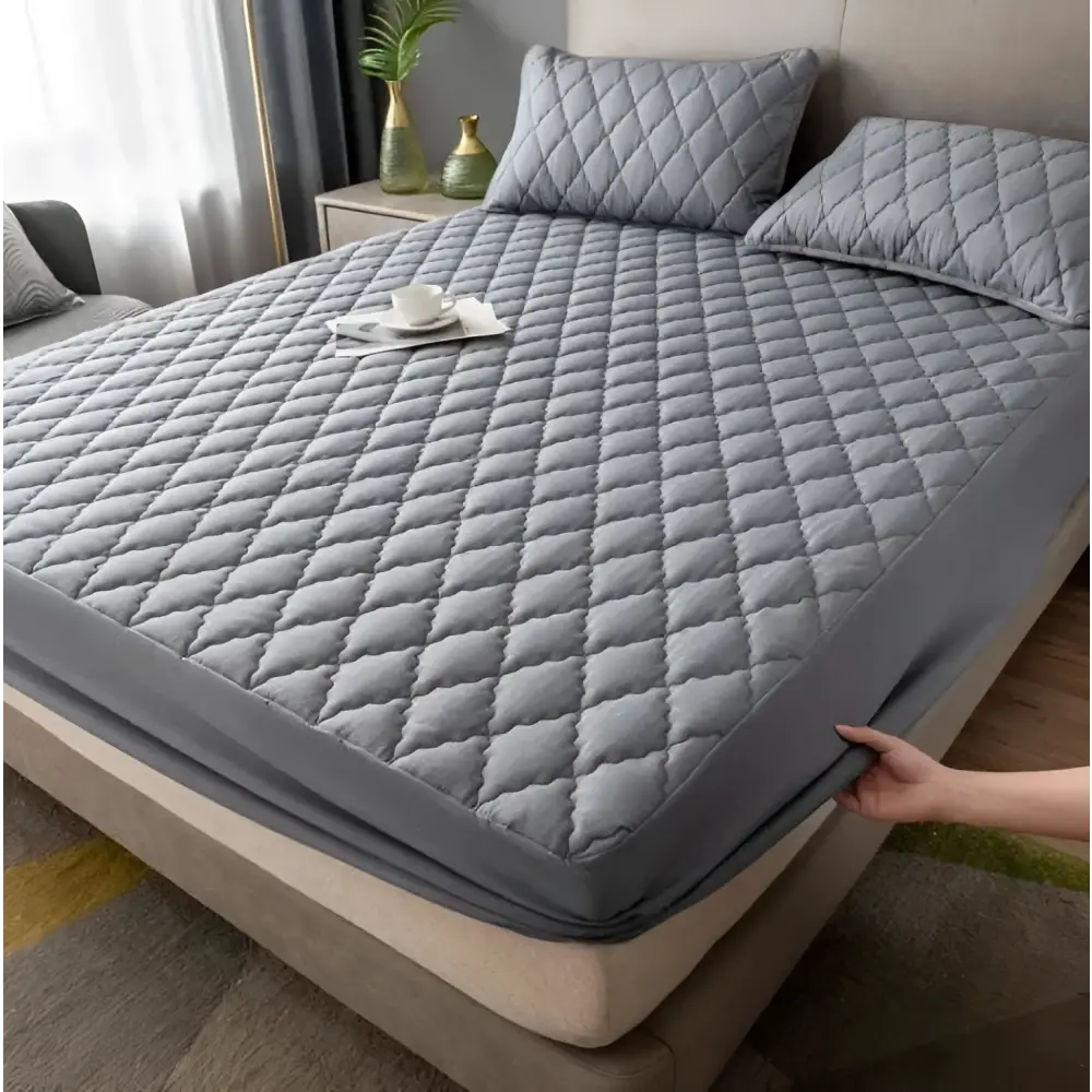 Gray quilted waterproof mattress protector with diamond stitching and elastic edge designed for kids beds