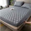 Gray quilted waterproof mattress protector with diamond stitching and elastic edge for kids bedding