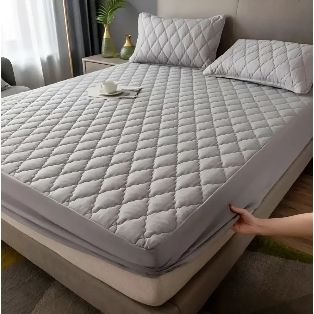Gray quilted waterproof mattress protector with diamond pattern and elastic edge for kids mattress protection