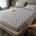 Gray quilted waterproof mattress protector with diamond pattern and elastic edge for kids mattress protection
