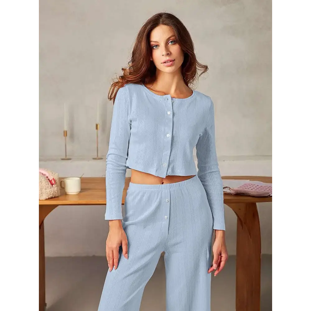 Light blue ribbed knit pajama set with button-front top and matching pants complementing white ribbed knit fashion cardigan
