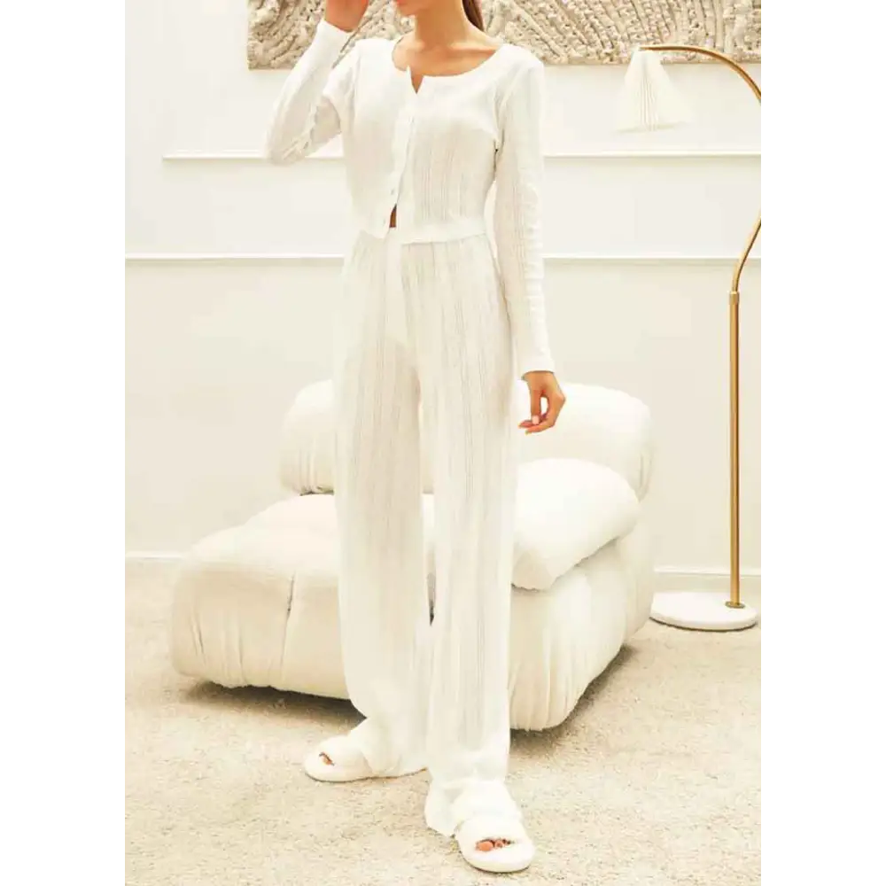 White ribbed knit fashion cardigan with long sleeves front button closure and subtle vertical pleats