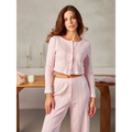 A soft pink long-sleeved button-up crop top with subtle vertical ribbing styled as a white ribbed knit fashion cardigan