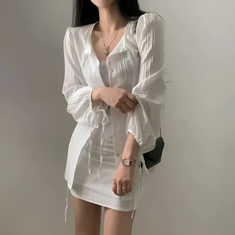 White sheer long sleeve shirt dress with puffed sleeves and tie waist featuring a drawstring waistband design