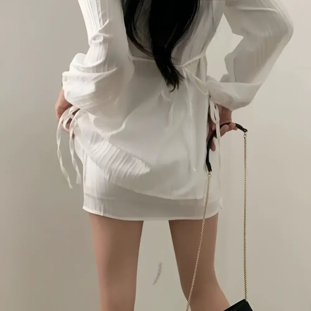 White ribbed long sleeve shirt dress with pleated detailing and tie waist side ties in sheer fabric