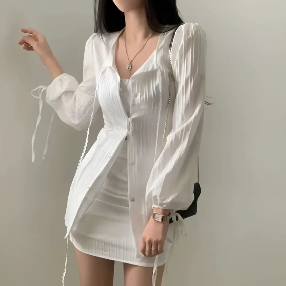 White ribbed long sleeve shirt dress featuring tie waist and tie details at the cuffs for a stylish look