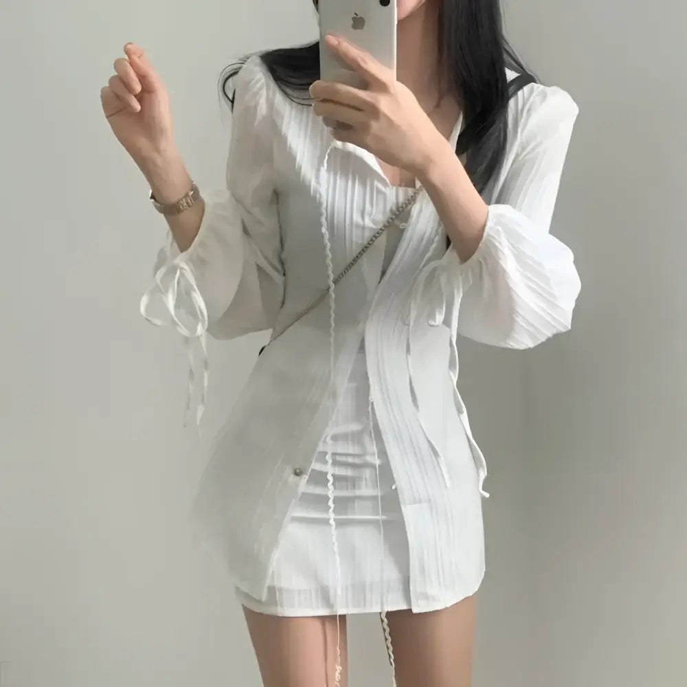 White ribbed long sleeve shirt dress featuring tie waist and tie details at the cuffs for a stylish look