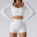 White ribbed long sleeve yoga set featuring chest pad slim fit with halter neck crop top and matching high-waisted shorts