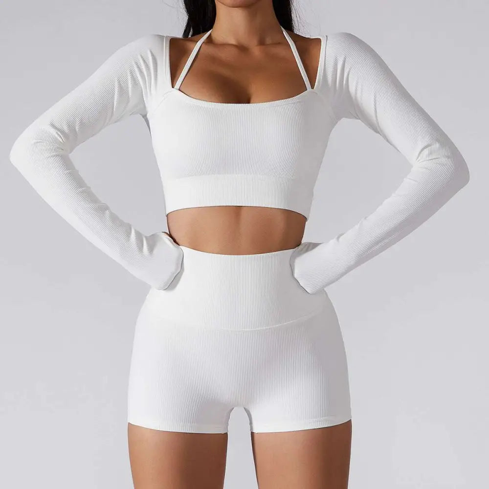 White ribbed long sleeve yoga set featuring chest pad slim fit with halter neck crop top and matching high-waisted shorts