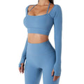 A matching blue ribbed long sleeve workout set featuring chest pad slim crop top with thin straps and high waisted leggings