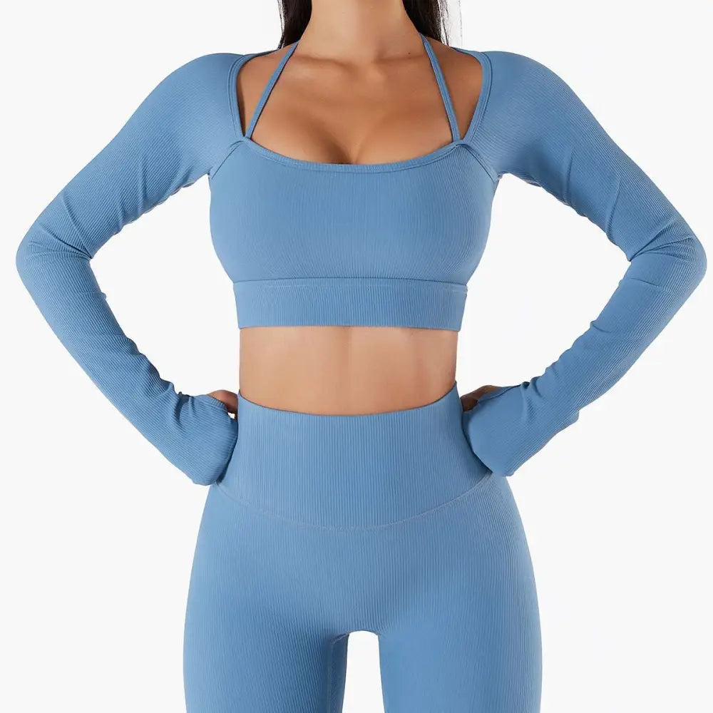 A matching blue ribbed long sleeve workout set featuring chest pad slim crop top with thin straps and high waisted leggings