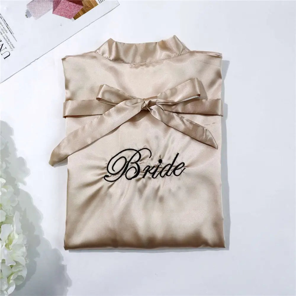 Beige satin bridal pajamas simulation robe with black bride embroidery and matching satin bow at neckline