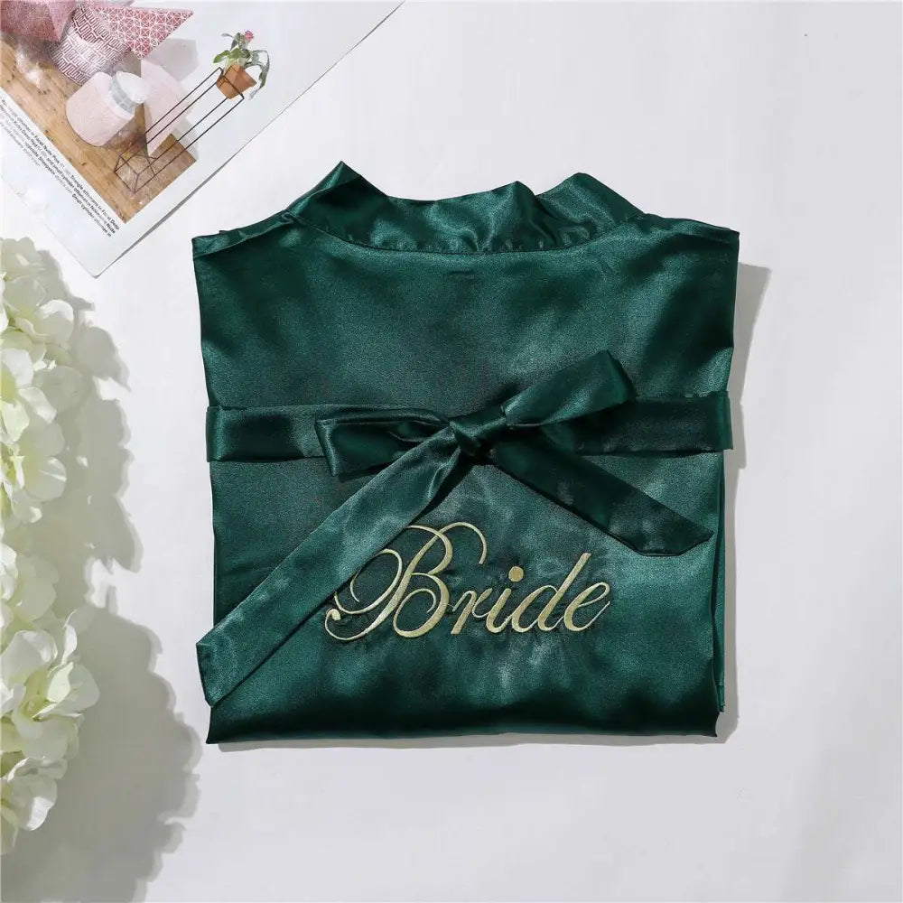 Emerald green satin bridal pajamas simulation with gold embroidered bride lettering and matching ribbon tie nightgown