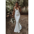 A sleek white satin evening gown with delicate spaghetti straps and a flowing train brigade for formal events