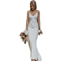 White satin evening gown with delicate spaghetti straps v-neckline and flowing train brigade design