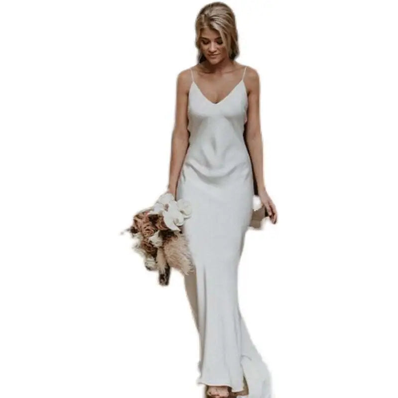White satin evening gown with delicate spaghetti straps v-neckline and flowing train brigade design