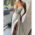 White satin gown with a dramatic feathered bodice and high slit designed for elegant plus size dresses occasions