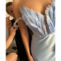 White satin gown with light blue feathered bodice shoulder detail sweeping the floor in plus size dresses collection