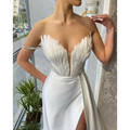 White satin gown with a feathered bodice strapless design and high slit suitable for plus size dresses