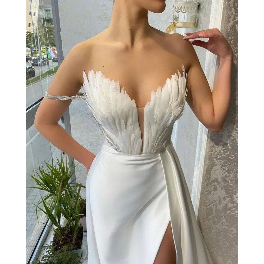 White satin gown with a feathered bodice strapless design and high slit suitable for plus size dresses