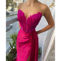 A vibrant fuchsia strapless gown featuring a feathered bodice and satin skirt suitable for plus size dresses