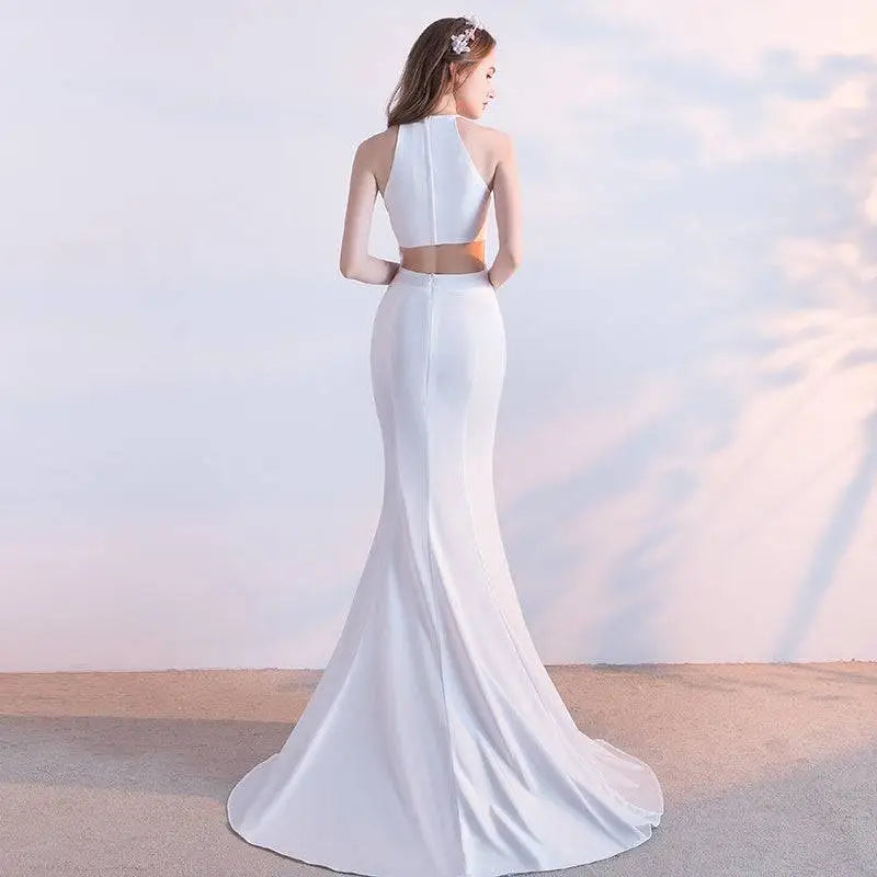White satin halter neck evening dress featuring a sleek mermaid-style two-piece design with fitted skirt length