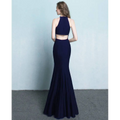 Navy blue mermaid-style two-piece gown with halter neckline and cutout back, styled as white satin halter neck evening dress