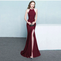 A sleek burgundy satin gown with a high neckline and thigh-high slit for an elegant neck evening dress look