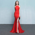 A striking red satin mermaid gown with high neckline and thigh-high slit complementing white satin halter neck evening dress