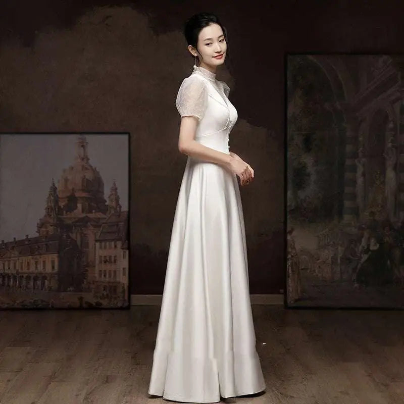Elegant white satin engagement wedding dress featuring sheer puff sleeves and a high neckline for formal occasions