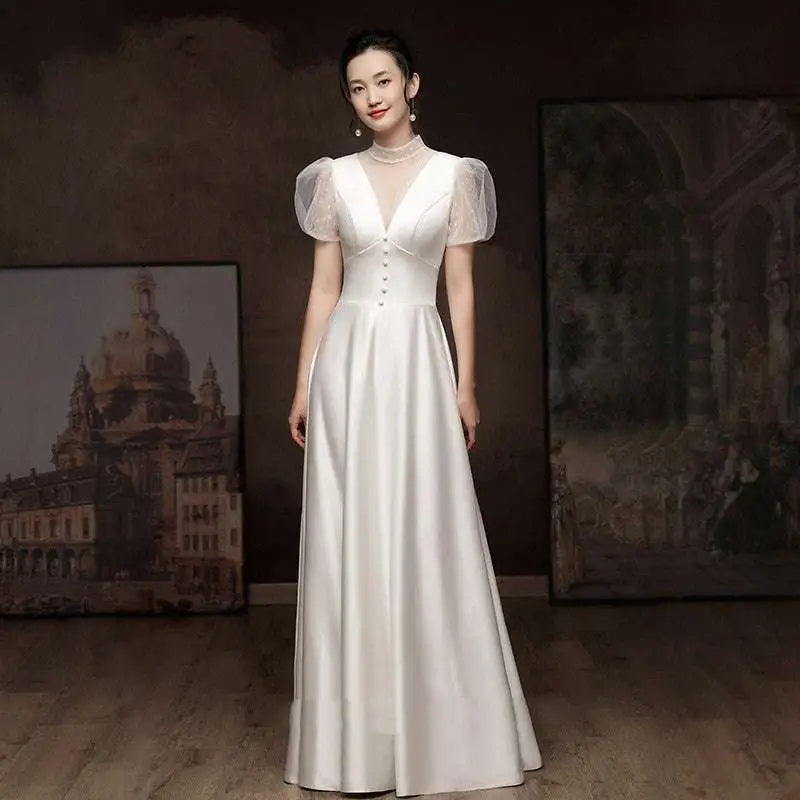 White satin engagement wedding dress with sheer puff sleeves and v-neckline in flowing satin material