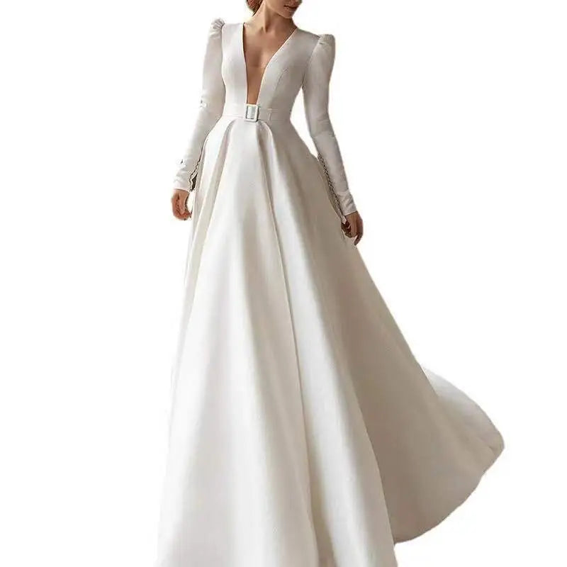 A white satin wedding dress with long skirt features a satin v neck, long sleeves, and a silver buckle belt